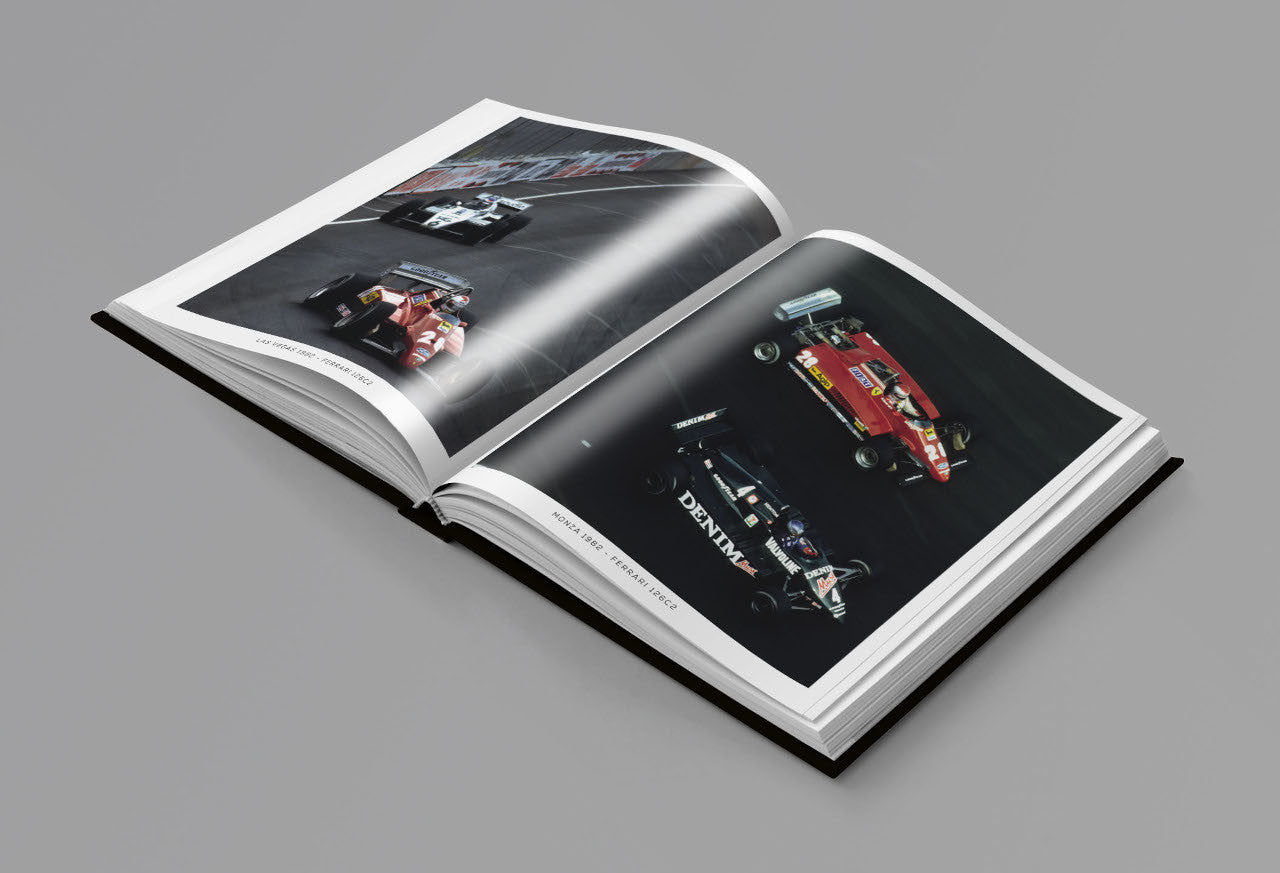 Open racing photo book with two car action photos and white text captions