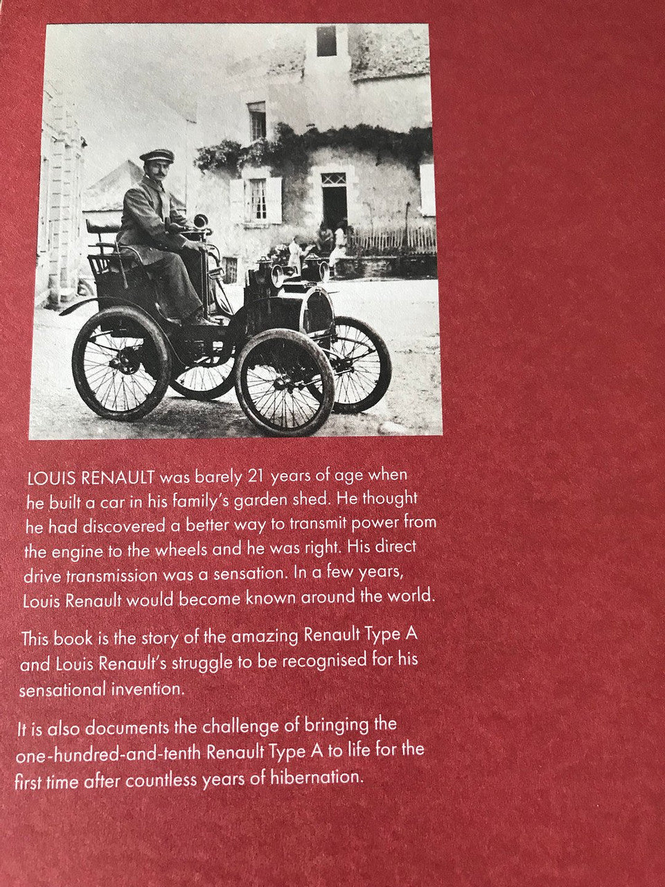Book page with vintage vehicle photo and printed text on red background