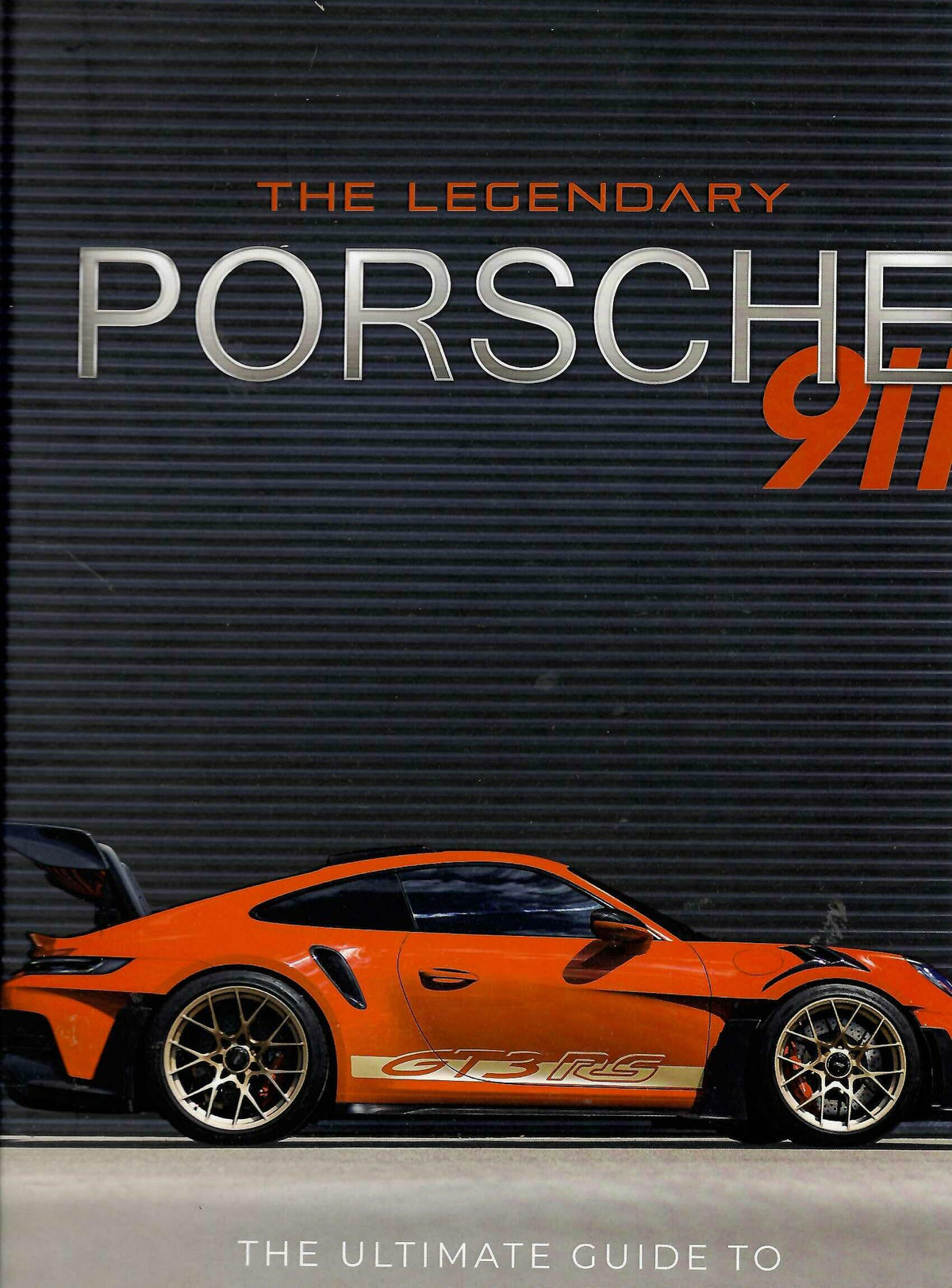 Hardcover Porsche 911 history book with orange GT3 RS car on the cover.