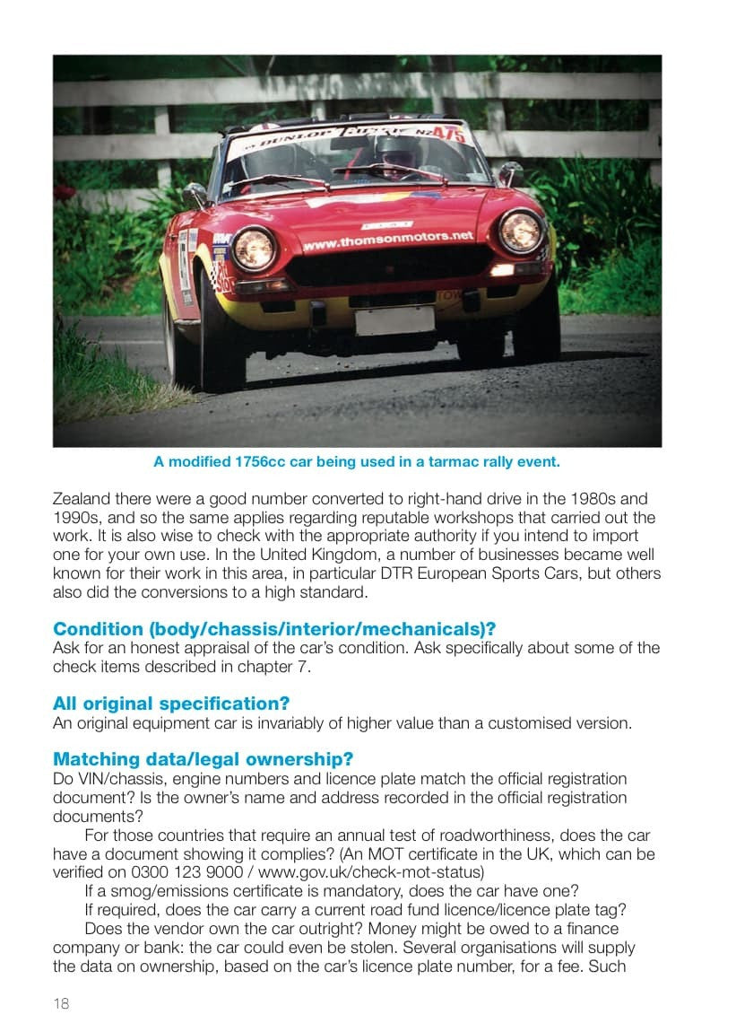 Front view of a classic red convertible sports car on a book page