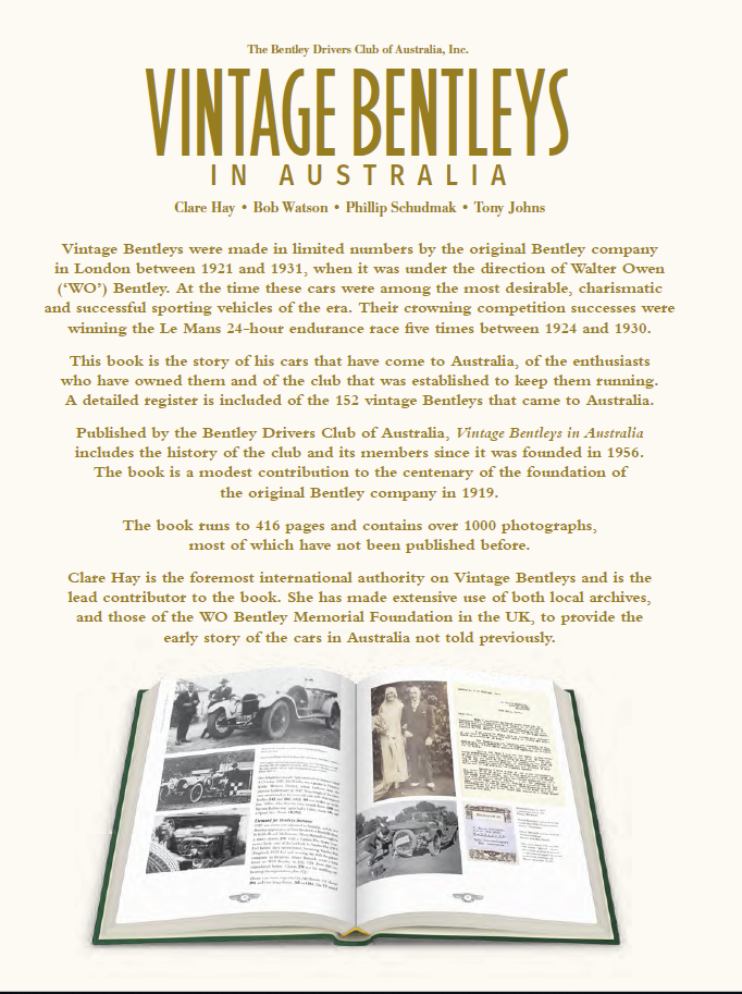 Vintage car photo book open to text pages with black-and-white vehicle photos