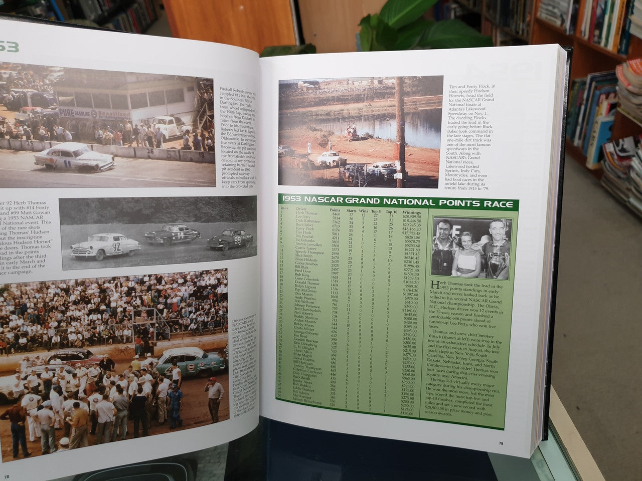Hardcover NASCAR history book open to Grand National points page with race photos and green chart