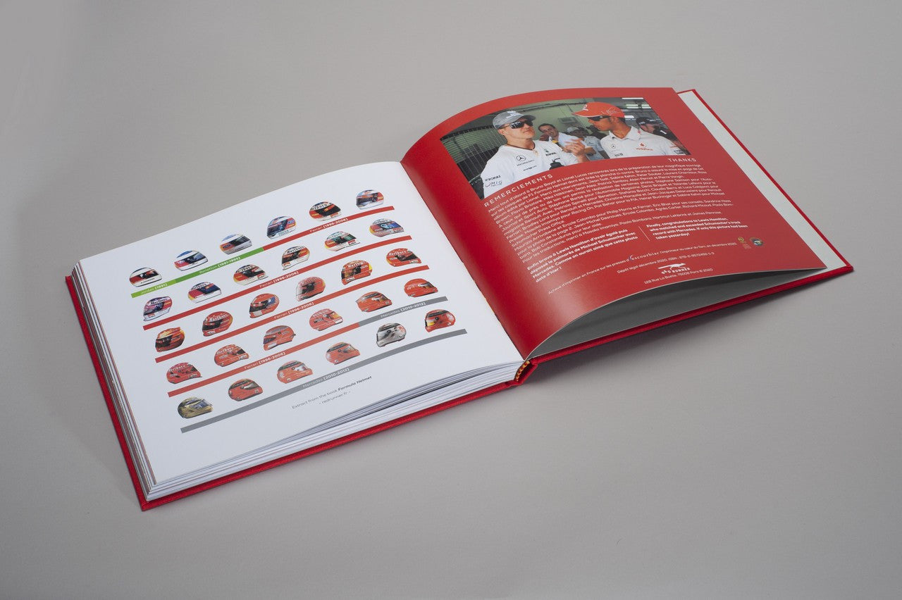 Open hardcover photo book with grid of small racing car portraits on white pages
