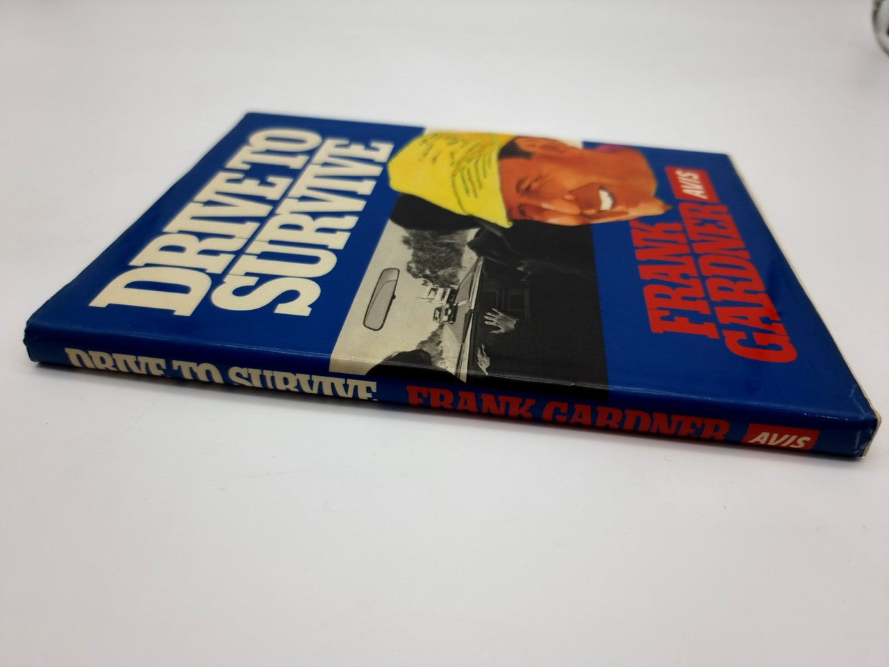 Driving survival book lying flat with blue cover and yellow cap portrait