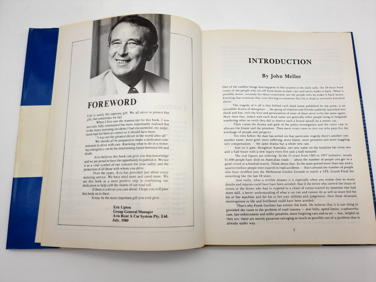 Driving survival book open to foreword and introduction pages with a portrait photo