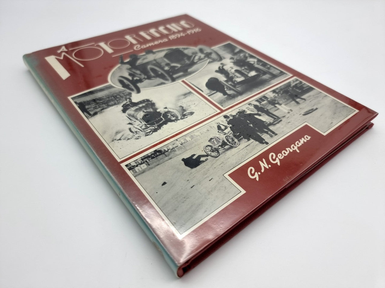 Hardcover book with maroon cover, racing-photo collage, and G.N. Georgano label