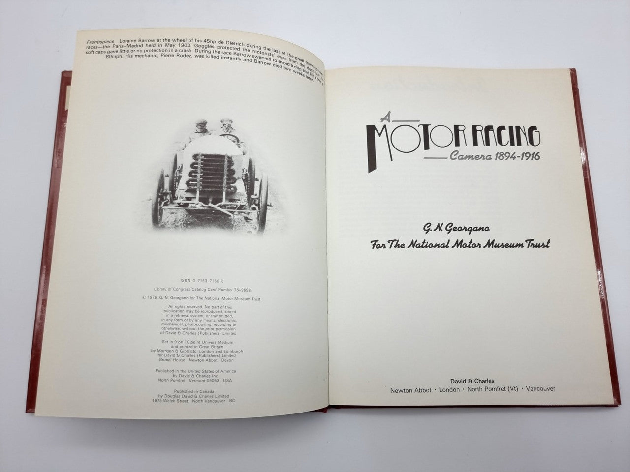 Open hardcover book showing black-and-white engine photo and caption text