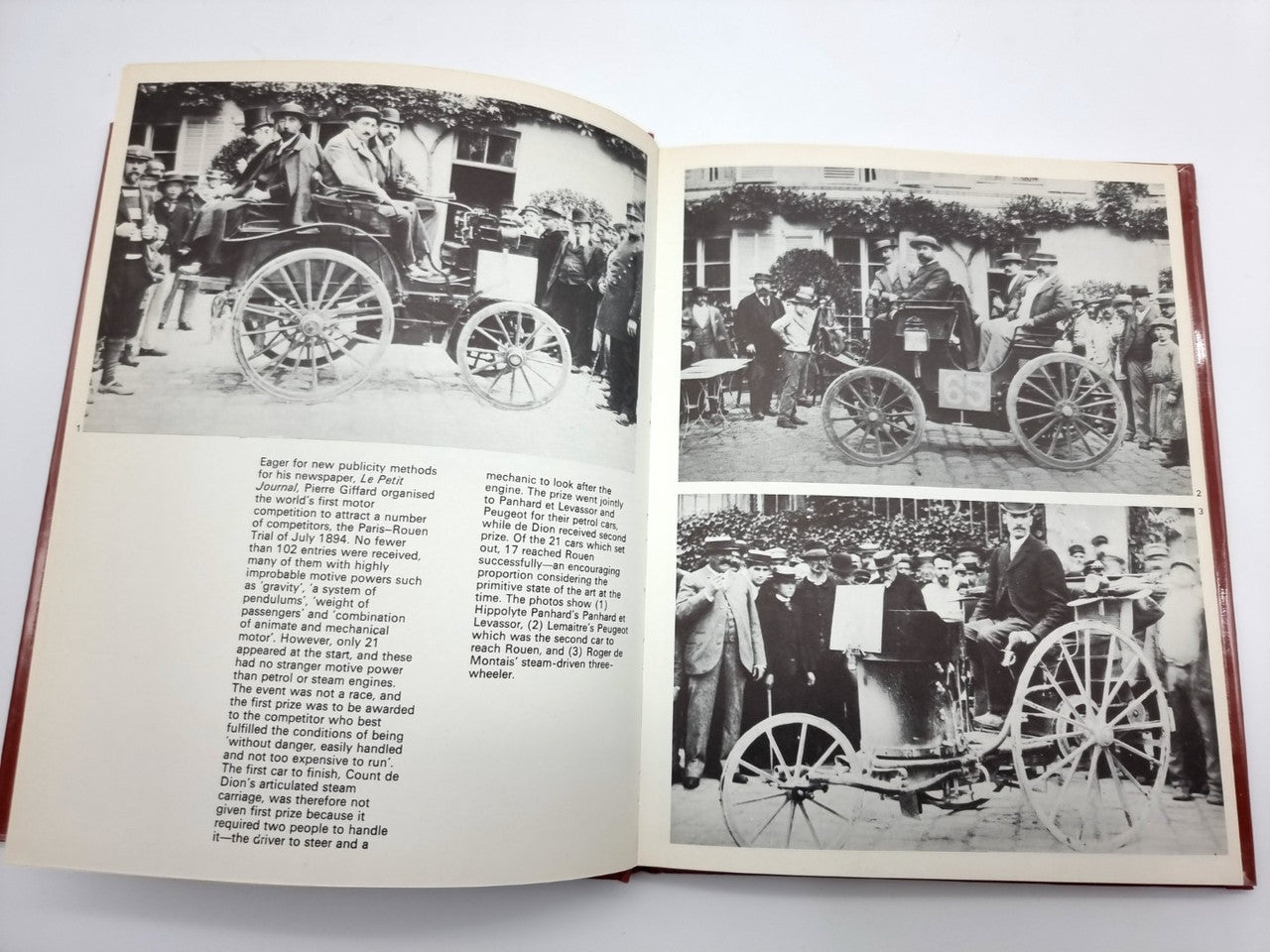 Open hardcover book with two pages of black-and-white vintage race-car photos