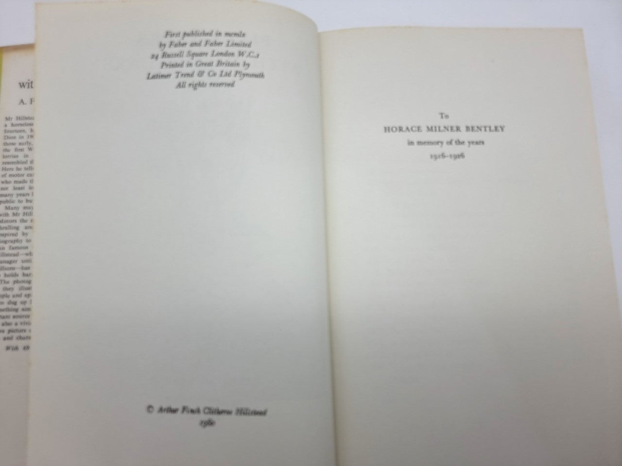 Softcover book open to early pages with small black text on cream paper.