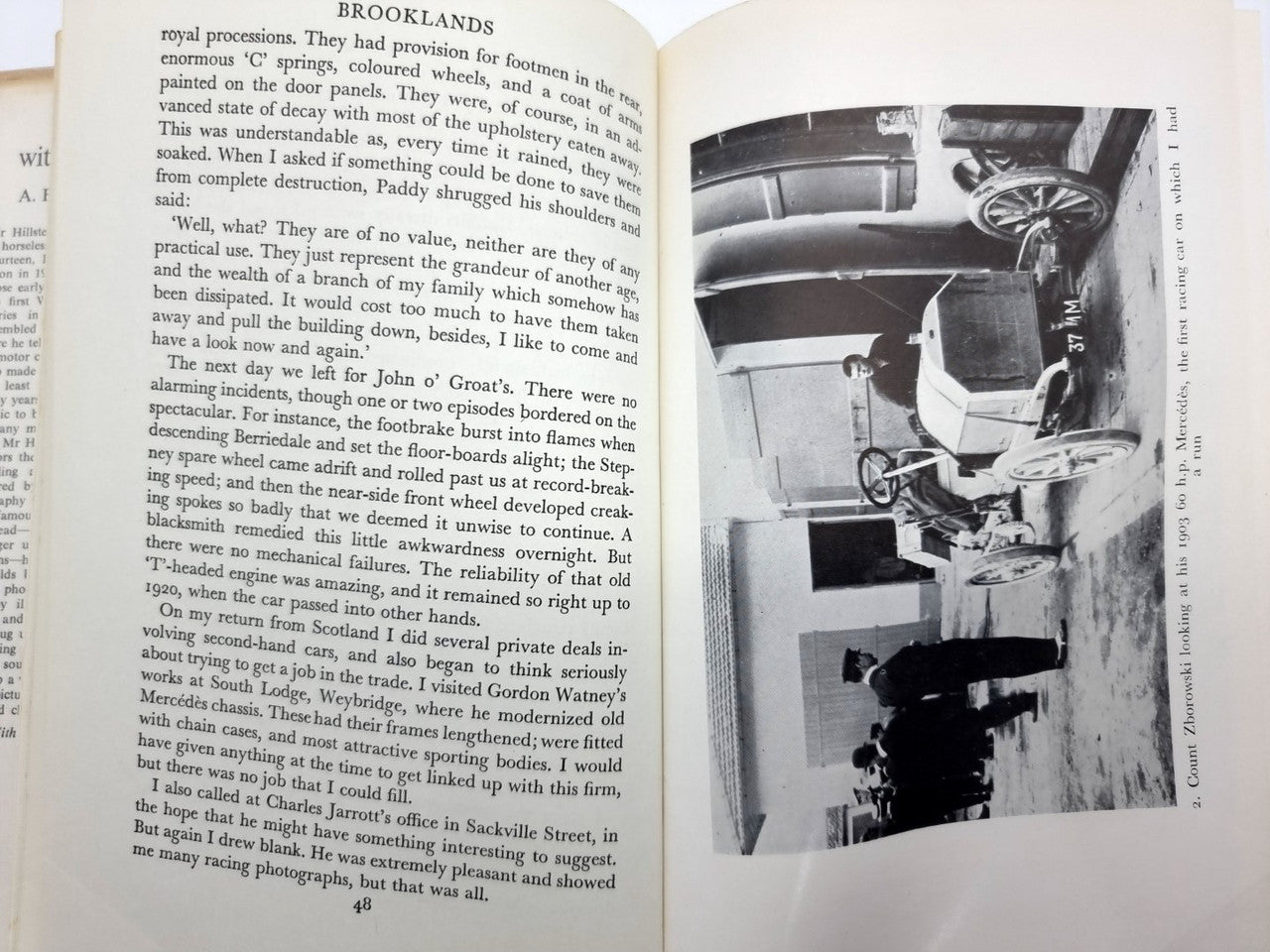 Open book spread with a black-and-white factory photograph beside printed paragraphs.