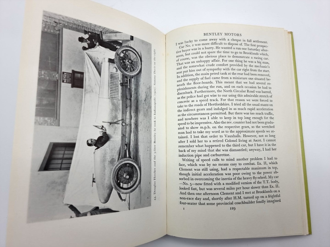 Open book spread with black-and-white photographs and printed article text.