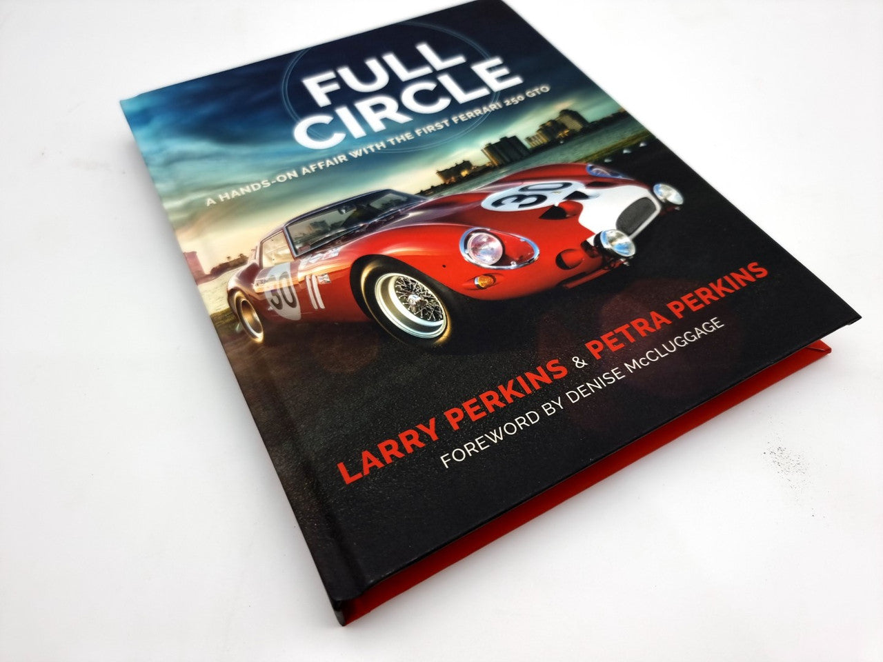 Hardcover book with a glossy cover showing a red Ferrari on track and author name text at bottom