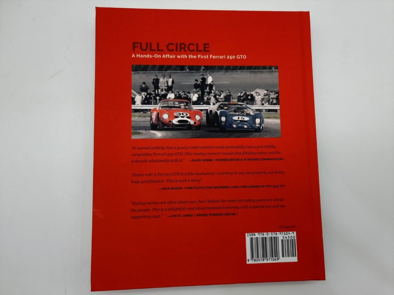 Hardcover book back cover in red with car photo band and a barcode near the bottom