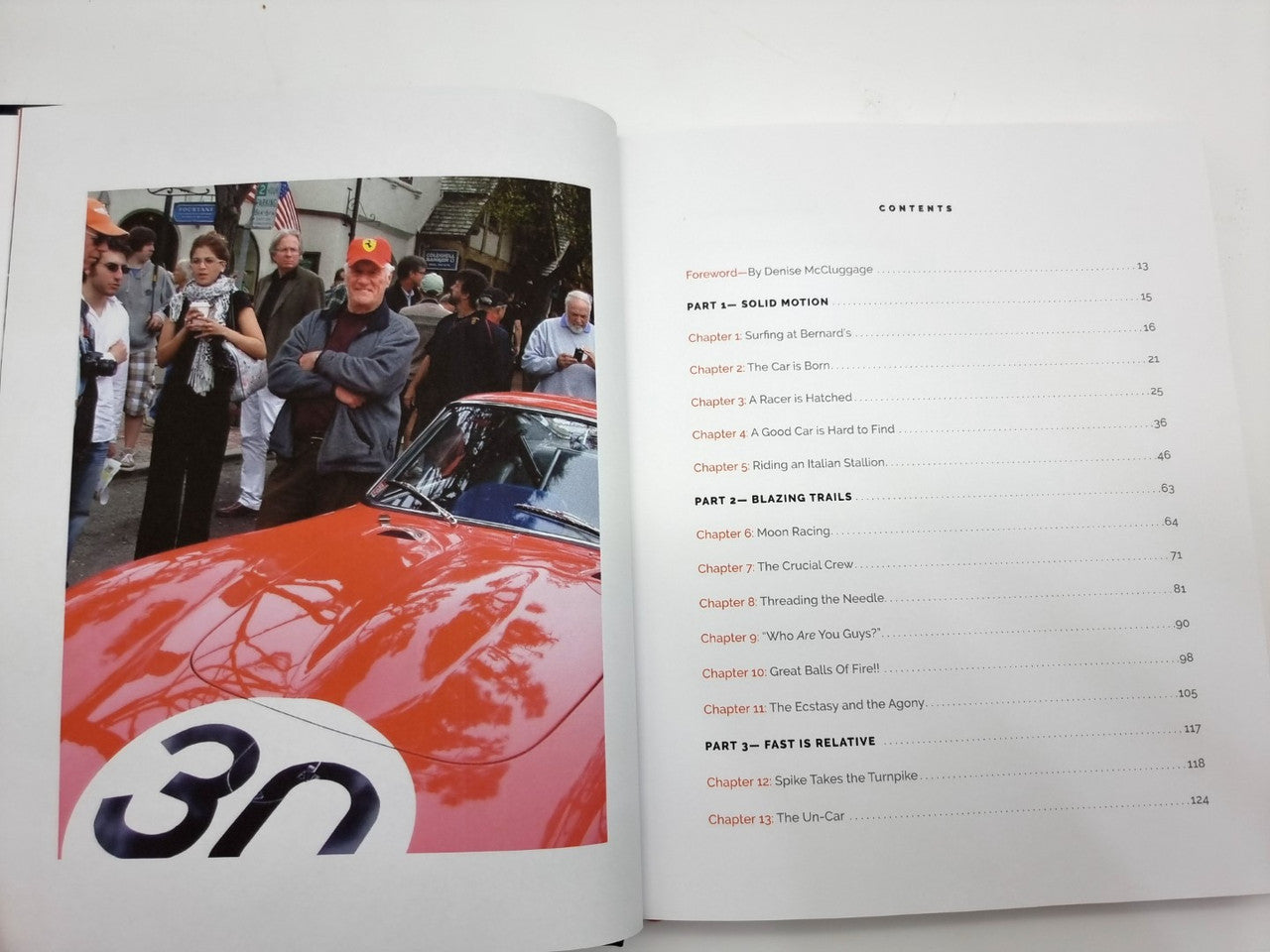 Hardcover book open to contents pages with photo of a red race car and “30” on the hood
