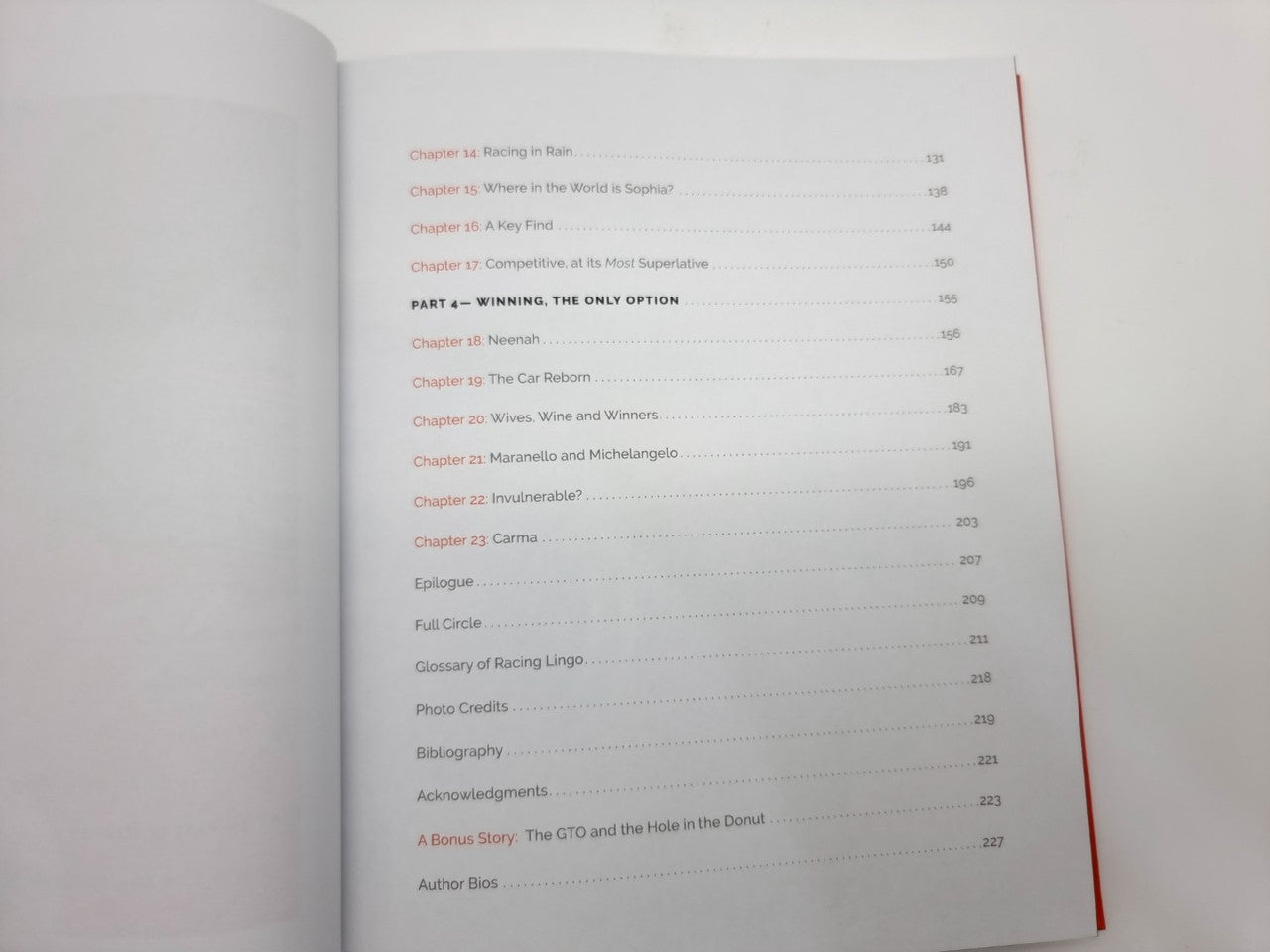 Hardcover book open to a table of contents list with page numbers and section headings