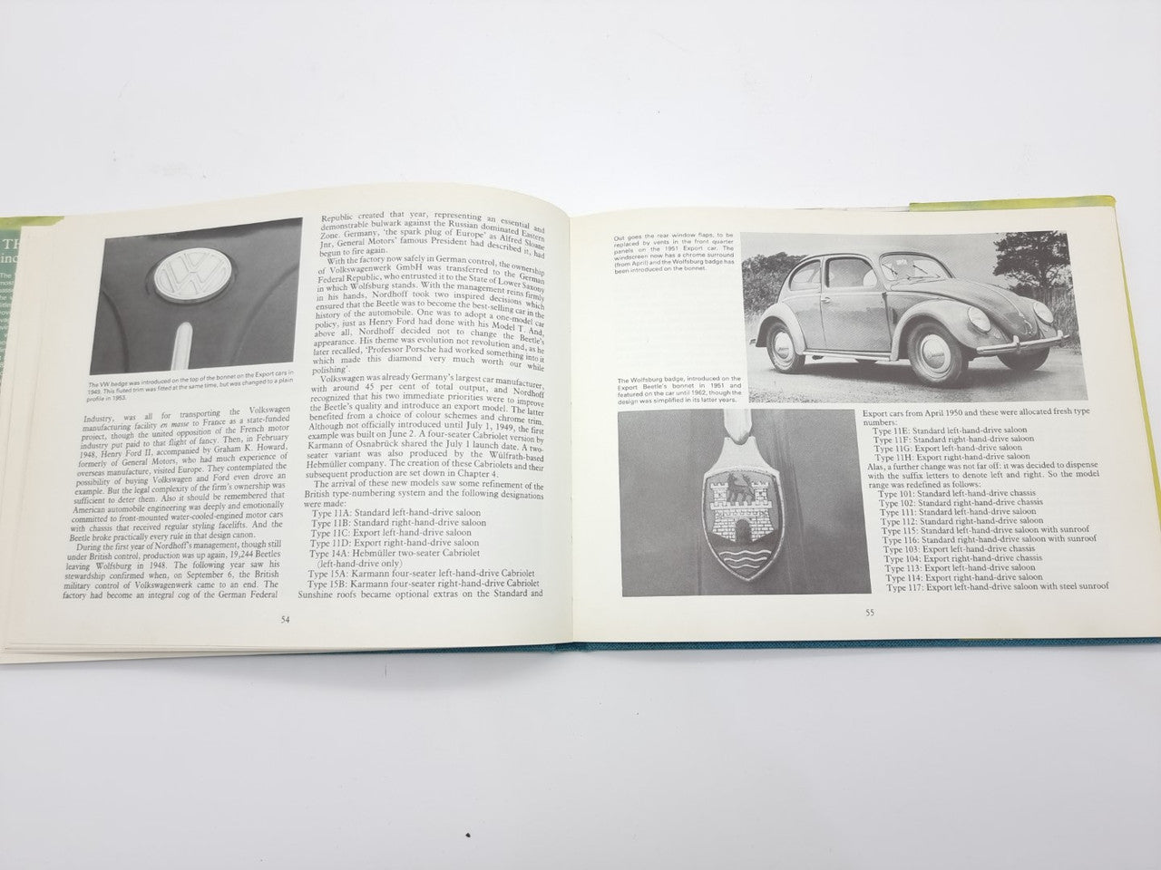 Volkswagen Beetle guidebook open, black-and-white car photos and diagrams