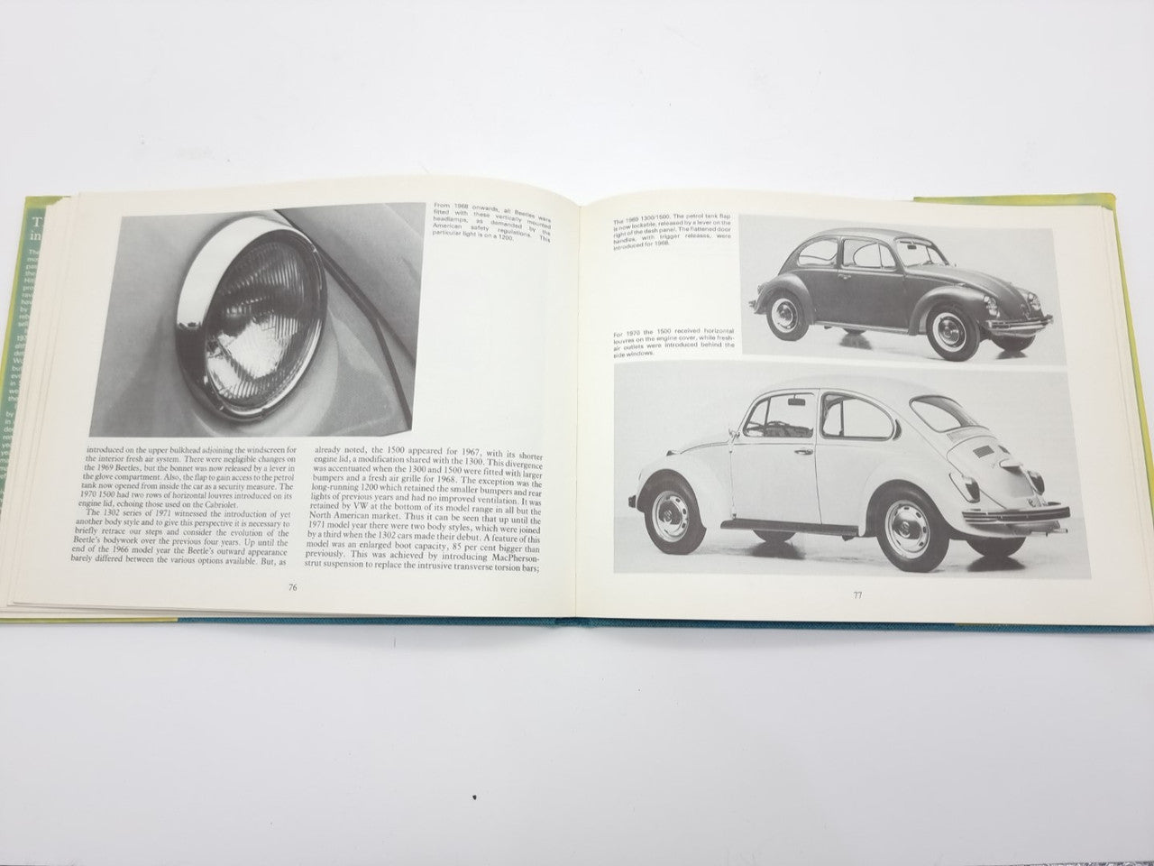 Volkswagen Beetle guidebook open, rear-view car photos and page text