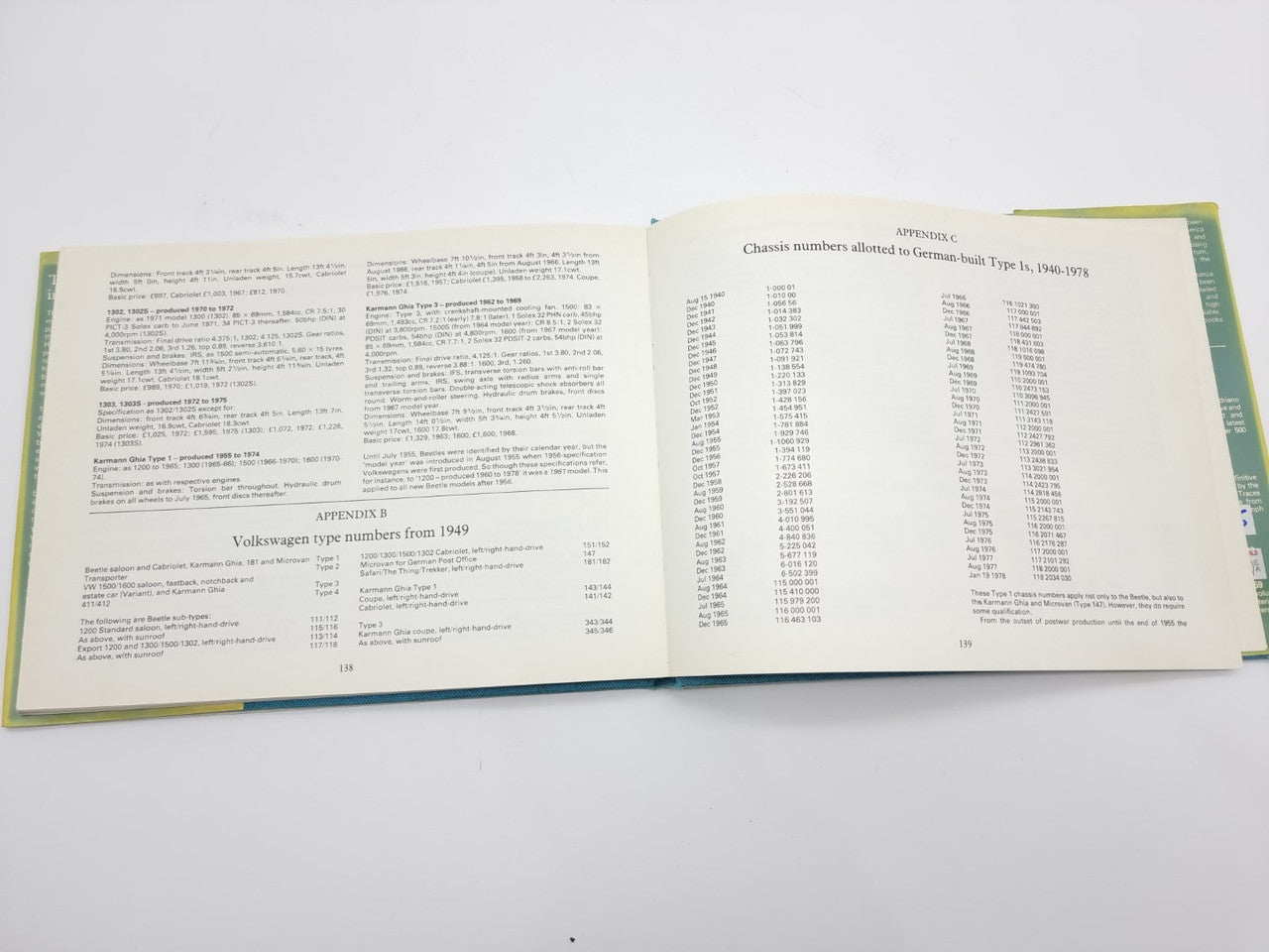 Volkswagen Beetle guidebook open, reference tables and explanatory text