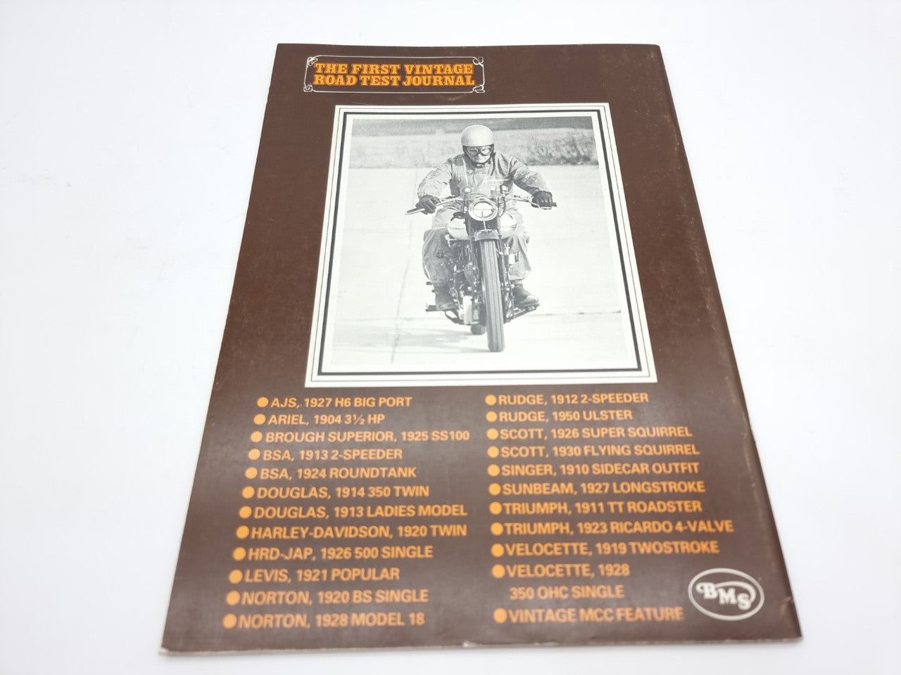 Vintage road test journal cover with motorcycle photo and model list