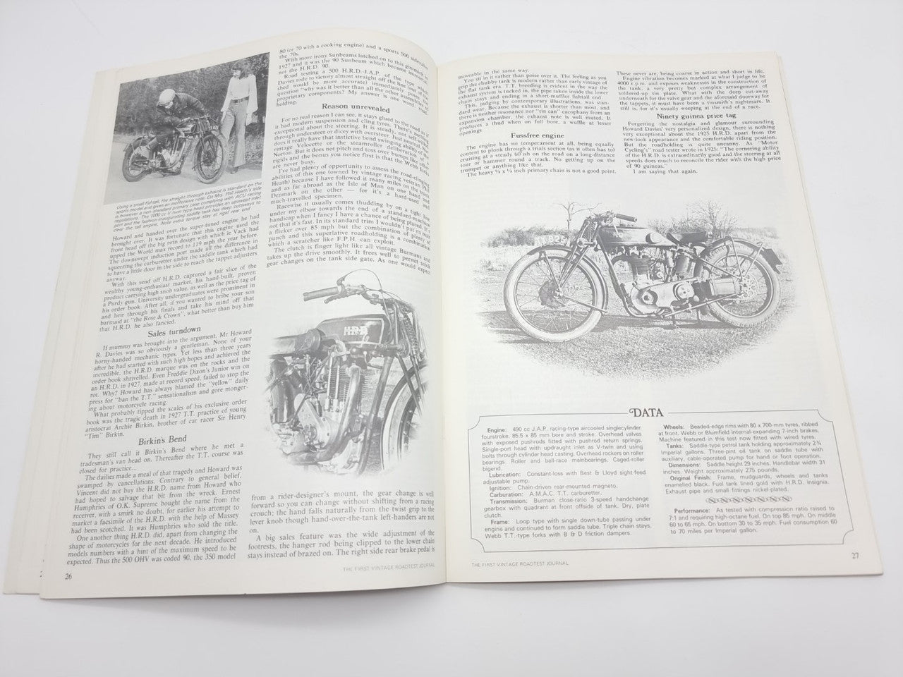 Vintage road test journal open pages with motorcycle photos and dense text columns