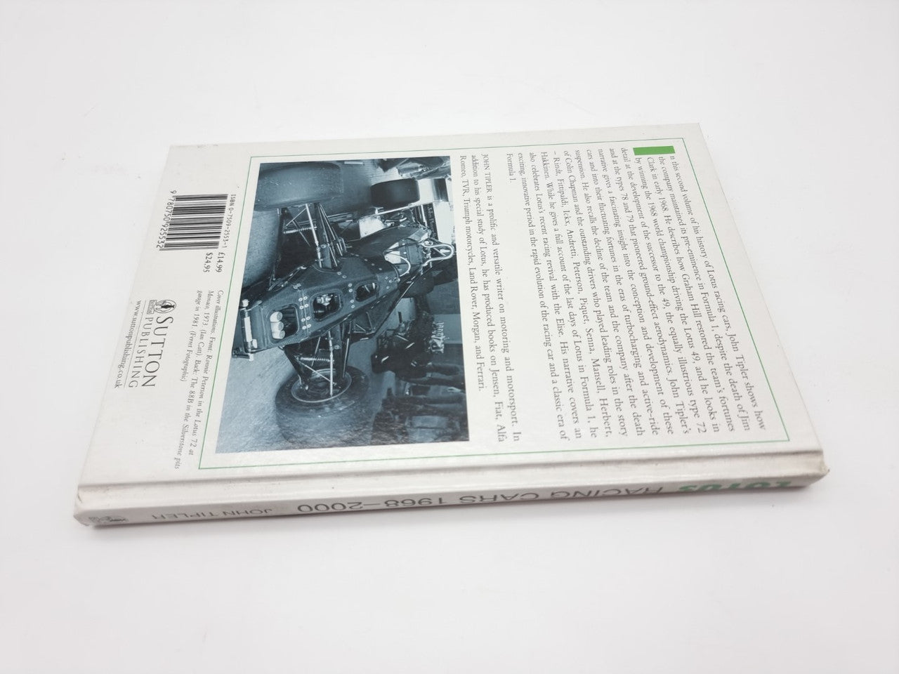 Auto racing book opened to a page with a black-and-white engine photo and text