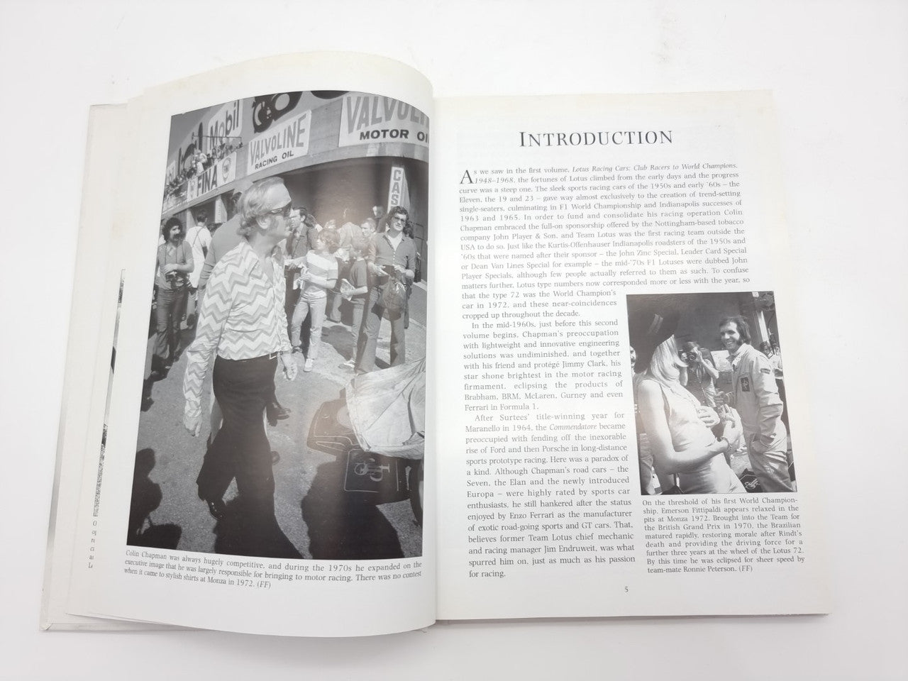 Open auto racing history book with a large left photo spread and right text section
