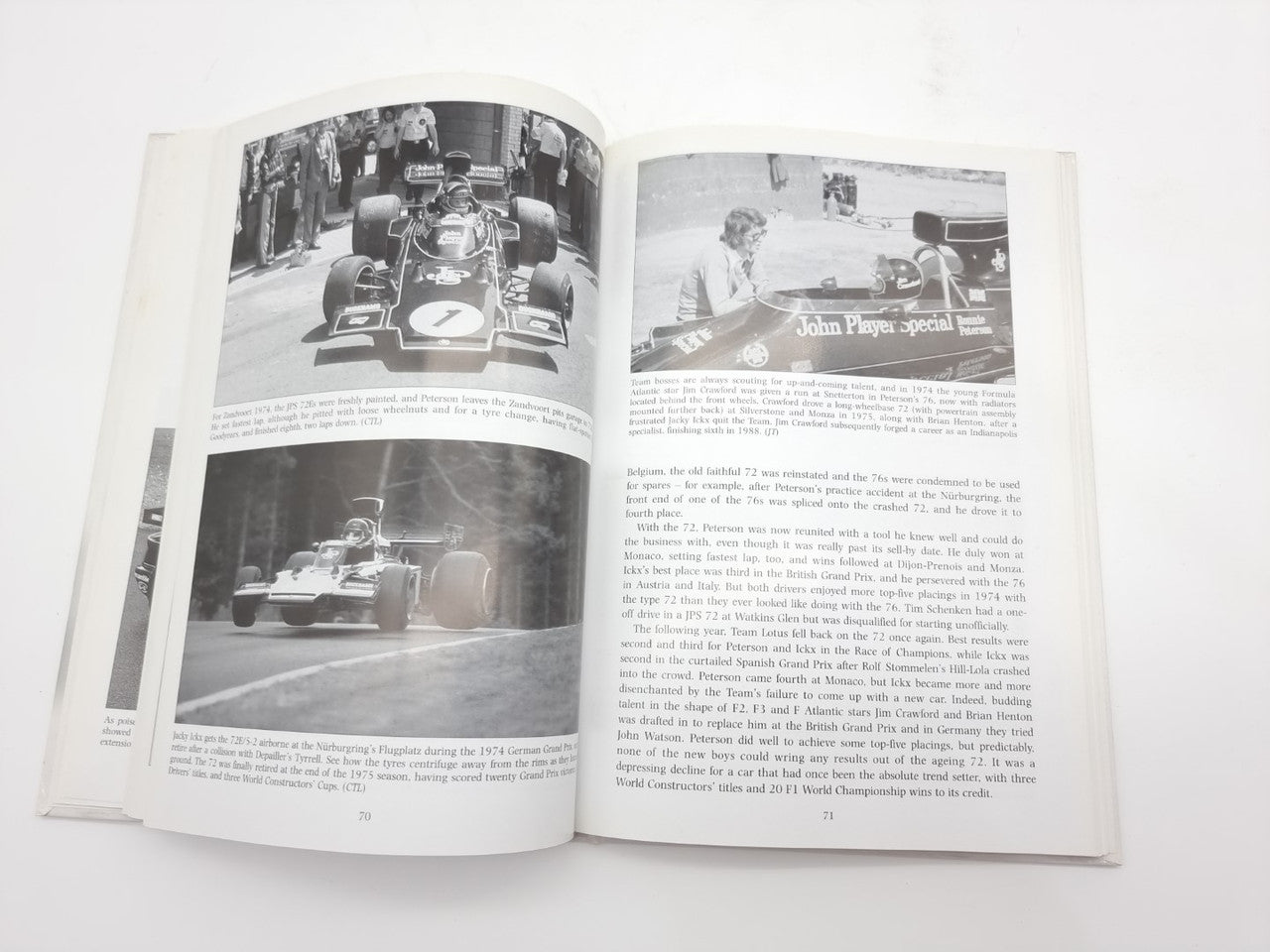 Open auto racing history book with black-and-white photos and captioned paragraphs