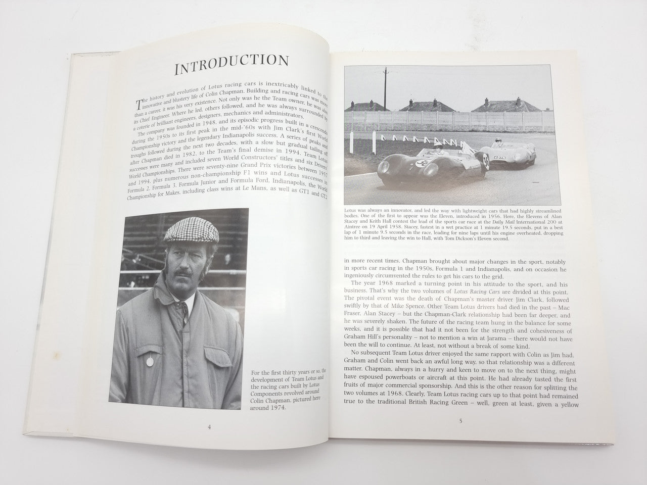 Open book with text pages and black-and-white racing photographs