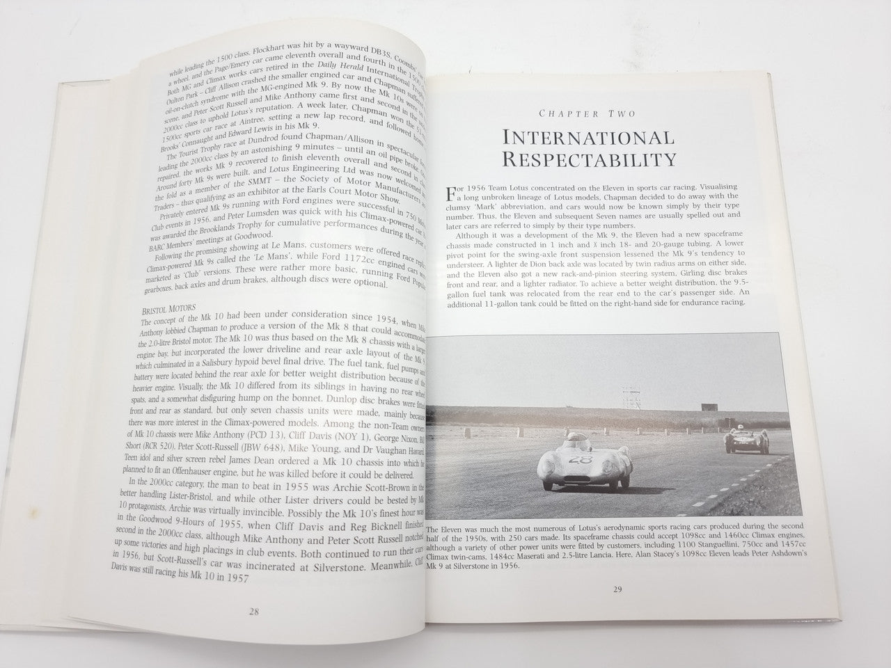 Open book spread with INTERNATIONAL RESPECTABILITY heading and race track car photo