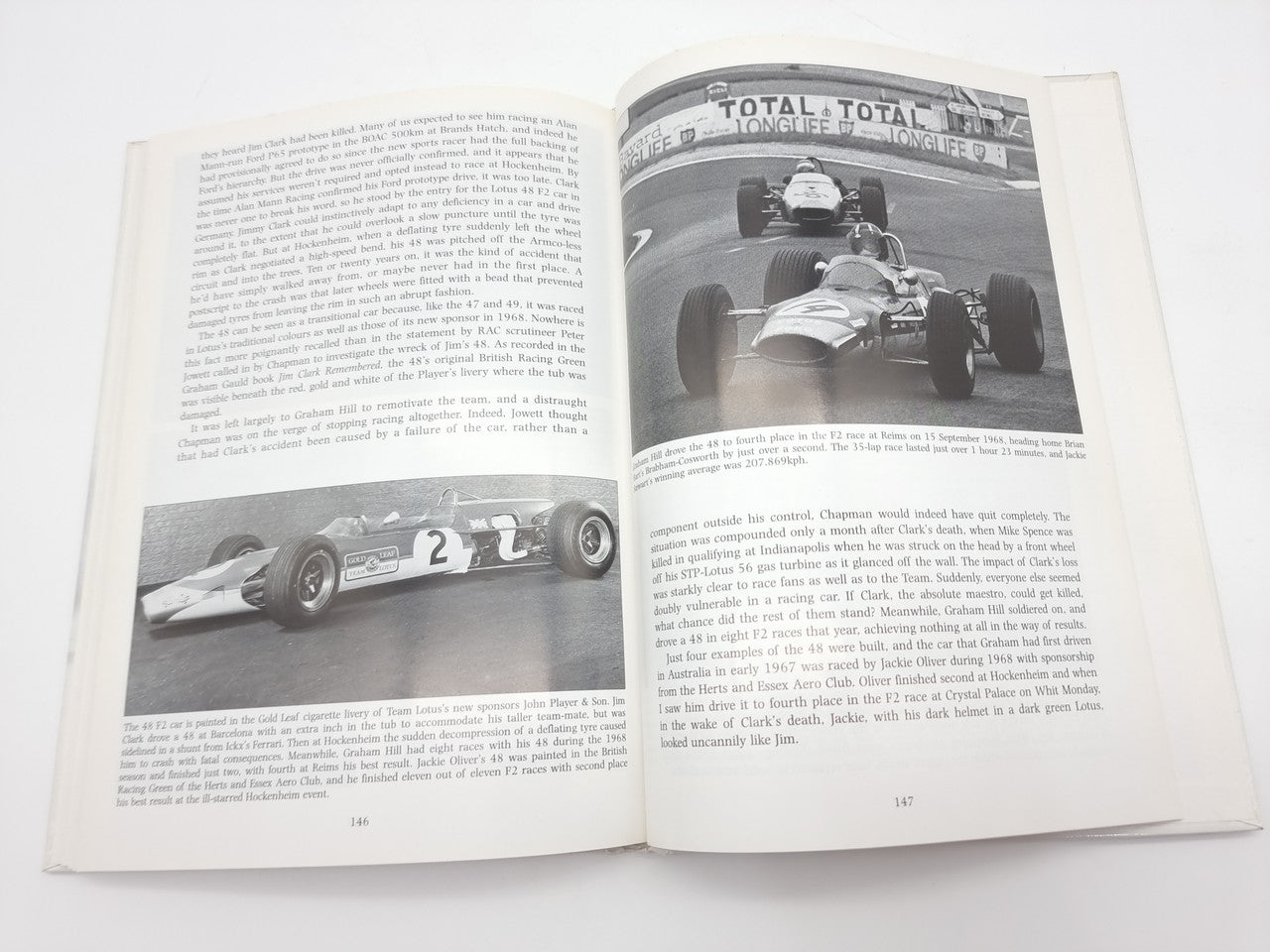 Open book spread with racing history text and black-and-white car images