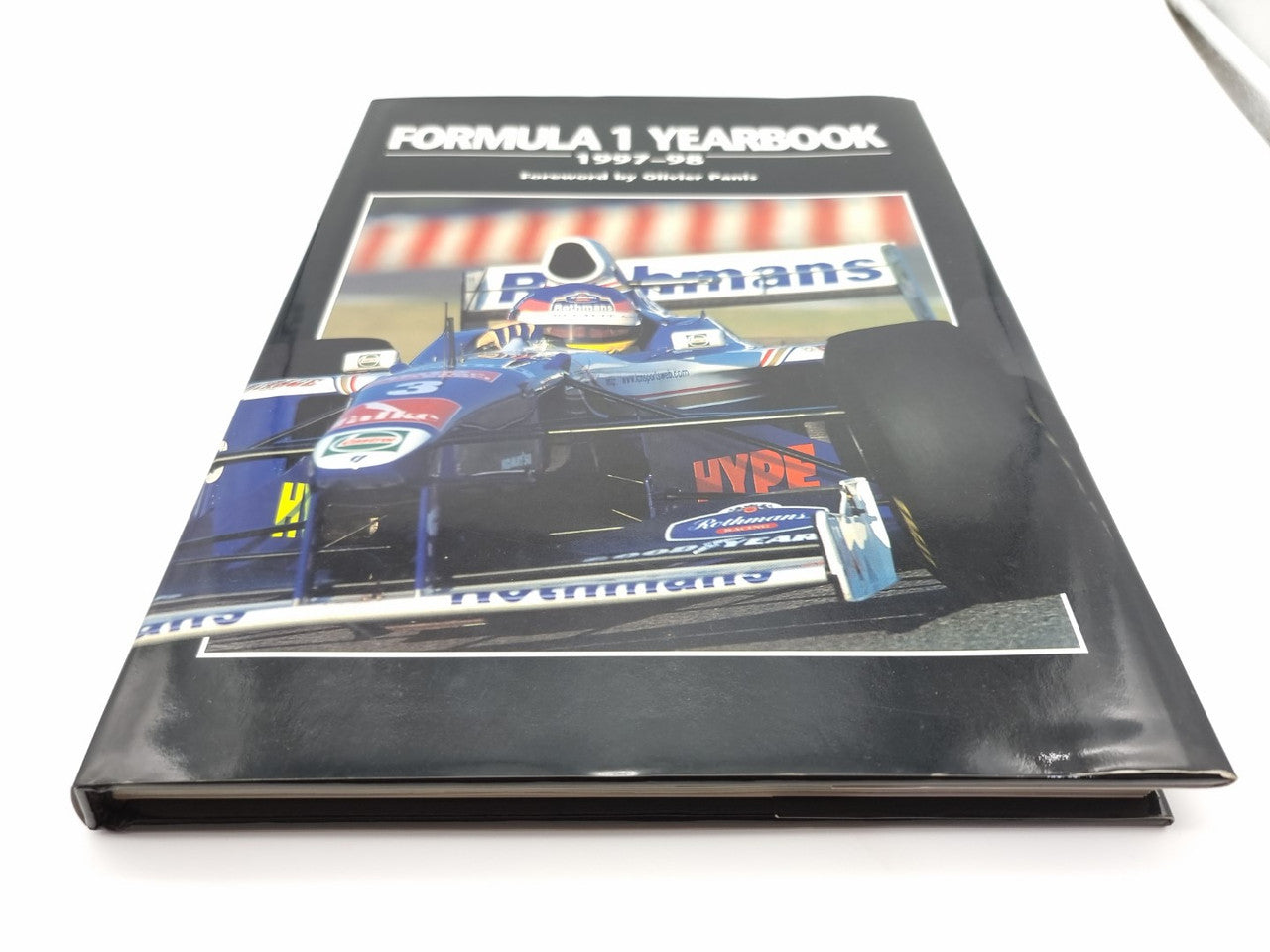 Motorsport yearbook front cover with race car artwork and title.