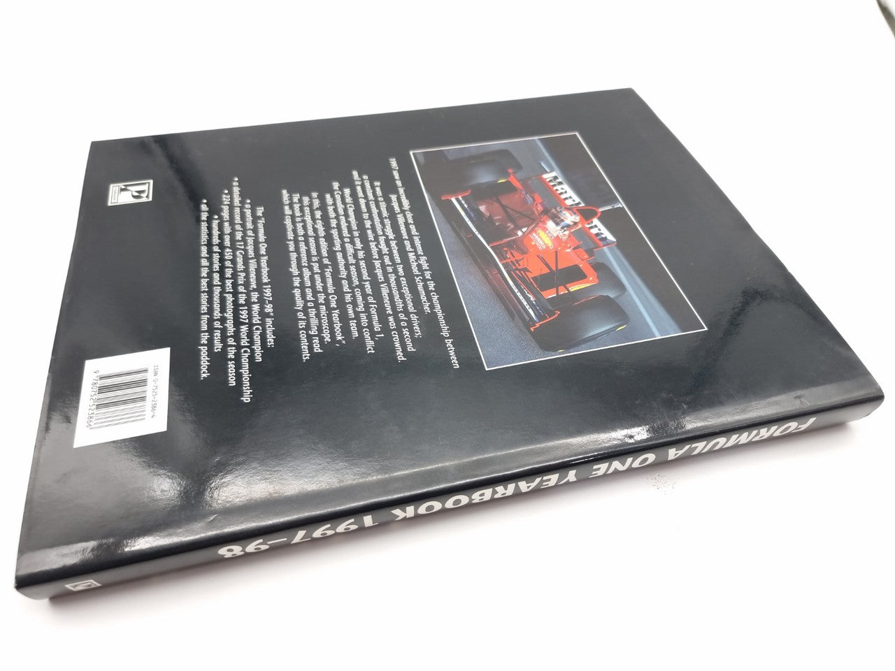 Black motorsport yearbook back cover with barcode and race car graphic.