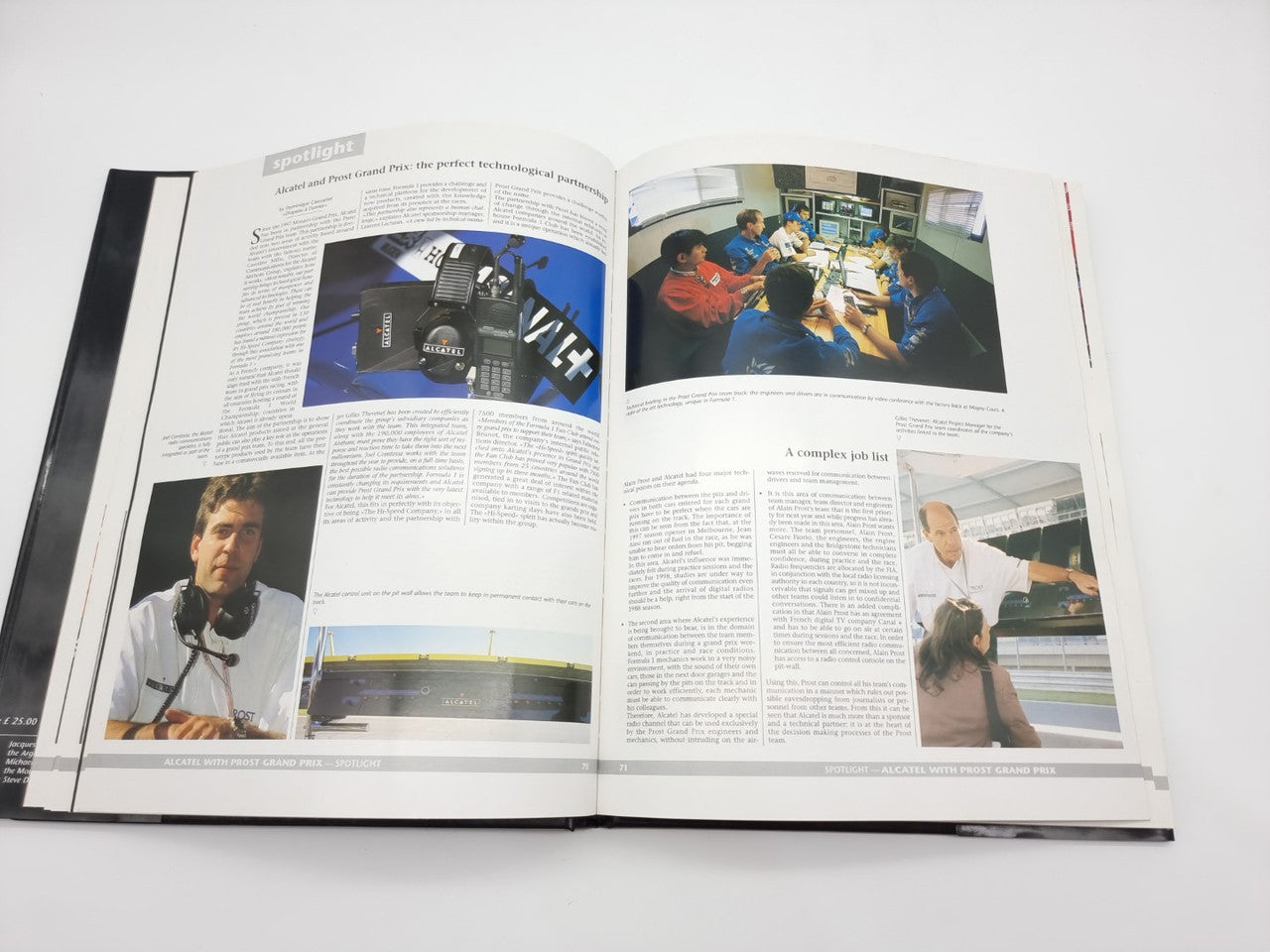 Open motorsport yearbook with race car photo and interviews across pages.