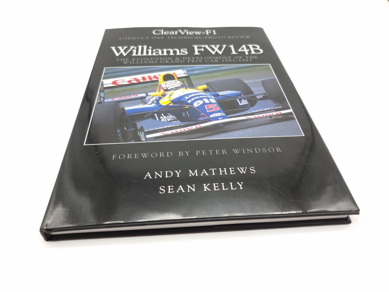 Hardcover motorsport book with black cover, blue race car image, and title text