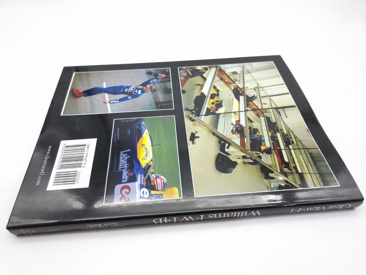 Hardcover book cover with race car photos and barcode on back