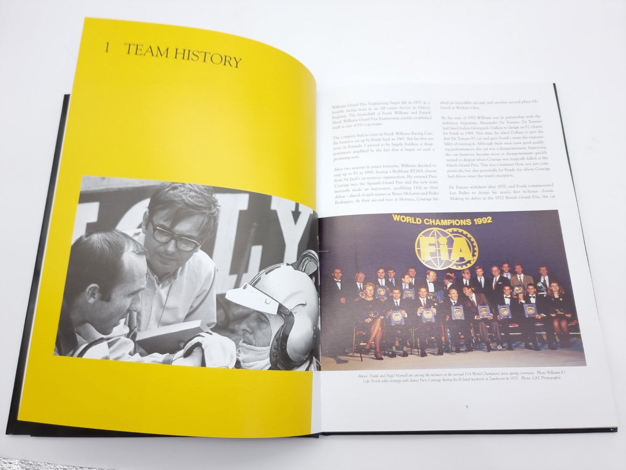 Open photo book spread with yellow title page and team history text and group photo