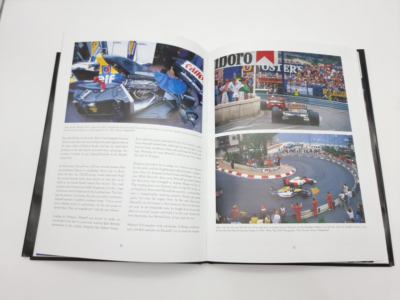 Open motorsport book spread showing car shots at track and pit lane