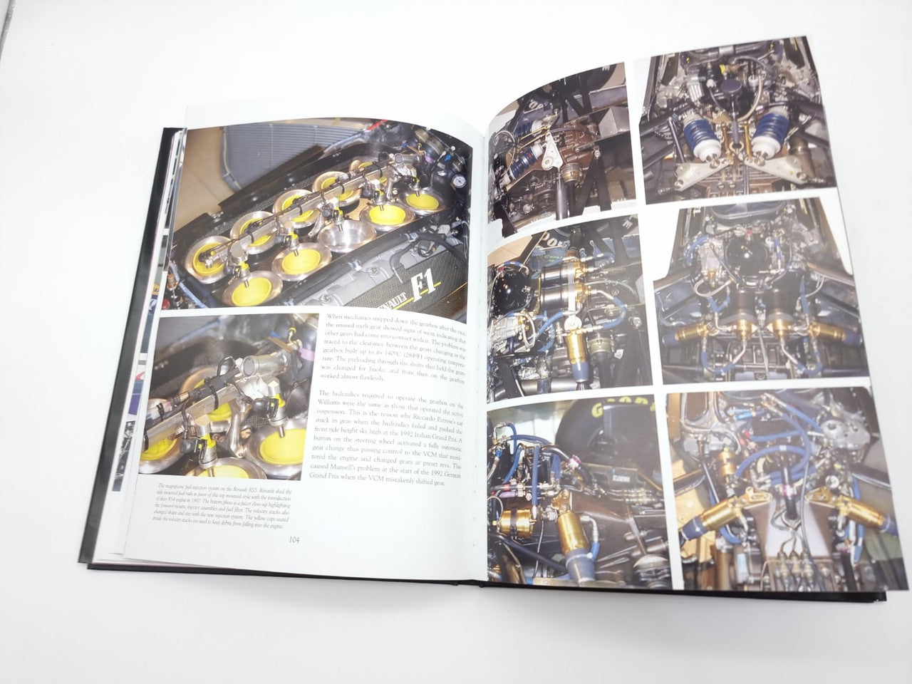 Open motorsport book page spread with multiple engine photos