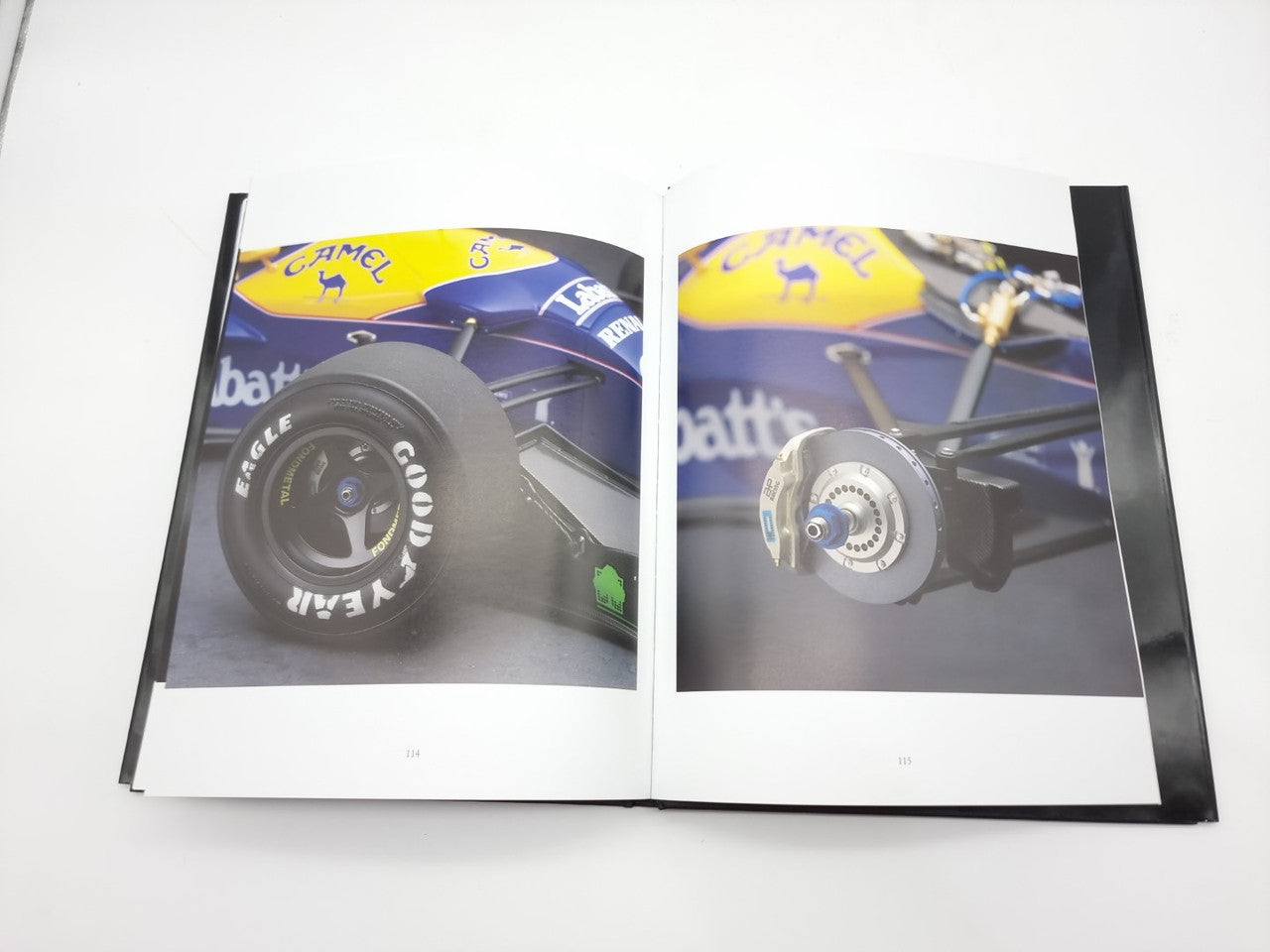 Open photo book spread with purple race car images on both left and right pages
