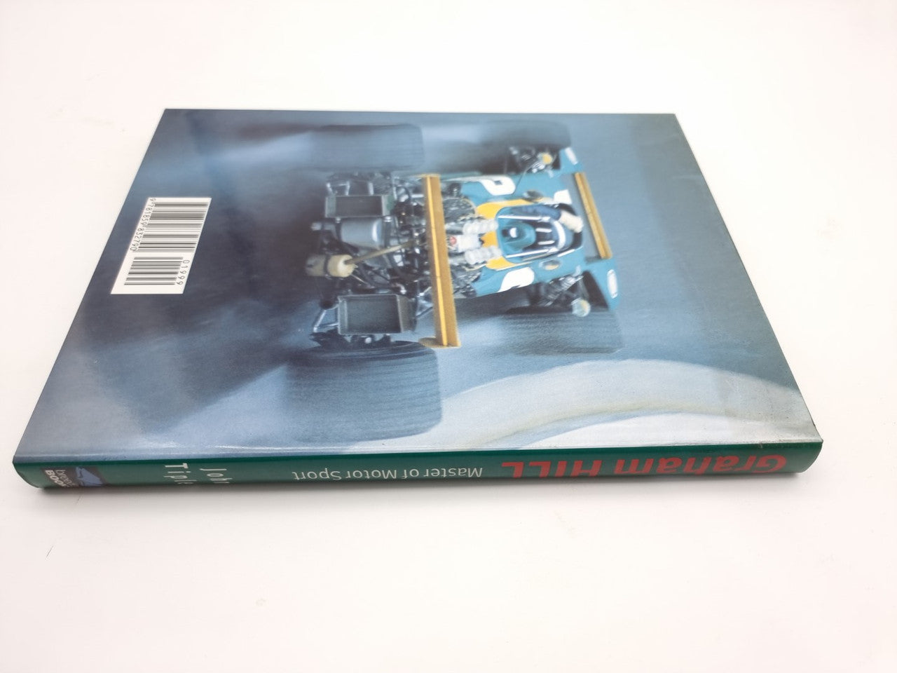 Motorsport book with car and track image on the cover, barcode on left