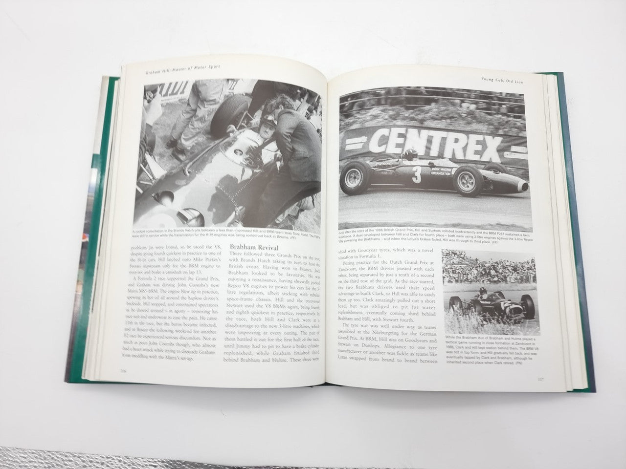 Open motorsport book showing two pages with black-and-white race photos