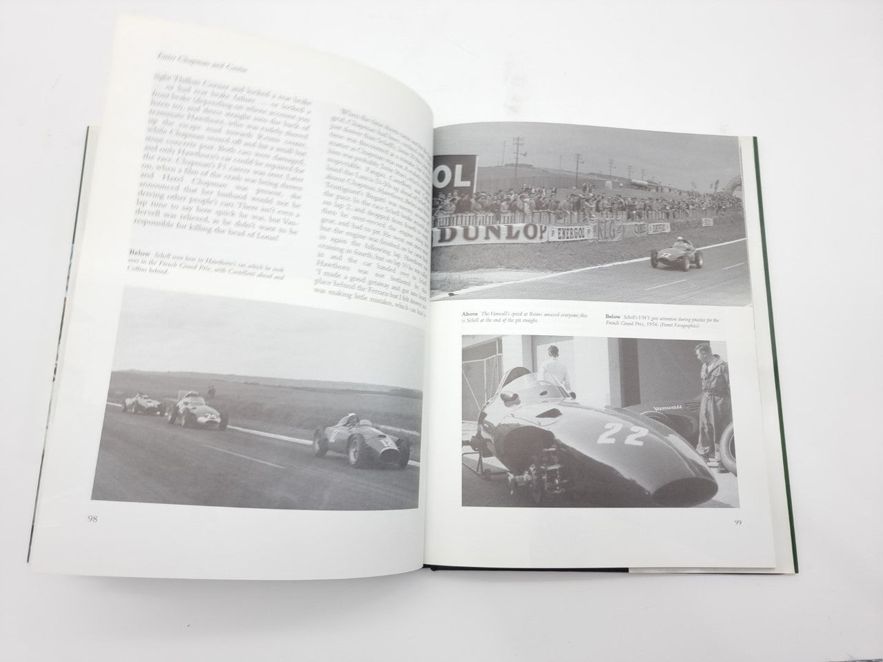 Open motorsport book with black-and-white car photos and printed text pages