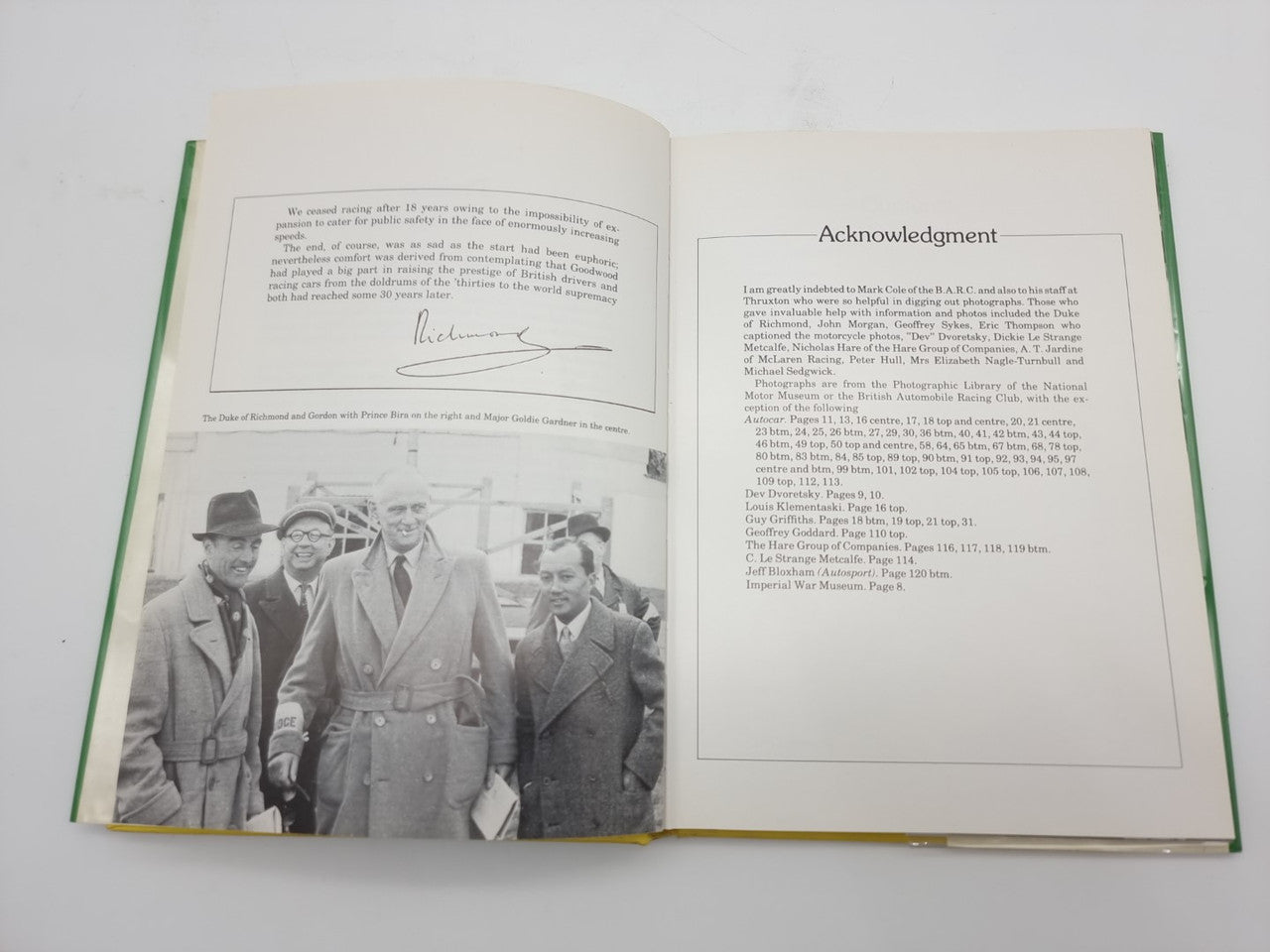 Hardcover book opened to acknowledgements and photo page with dated names