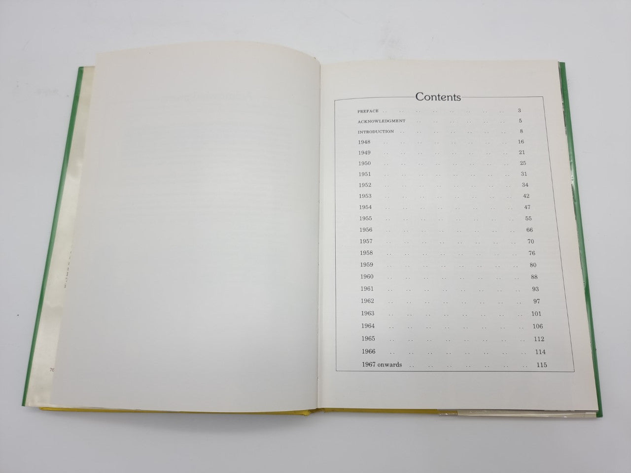 Hardcover book opened to contents page, table listing items, green page edges