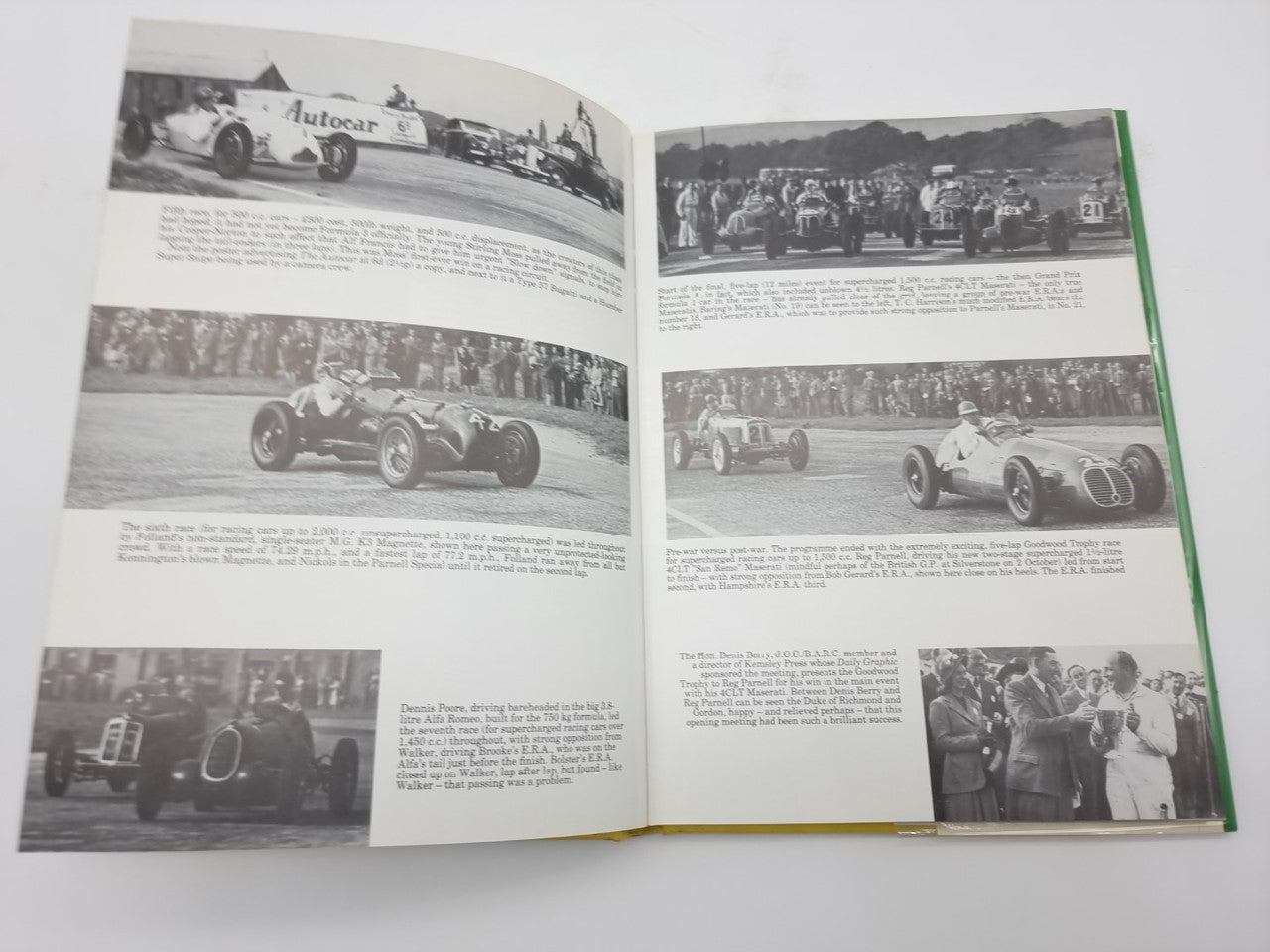 Open hardcover racing history book with multiple black-and-white race car photos and captions.