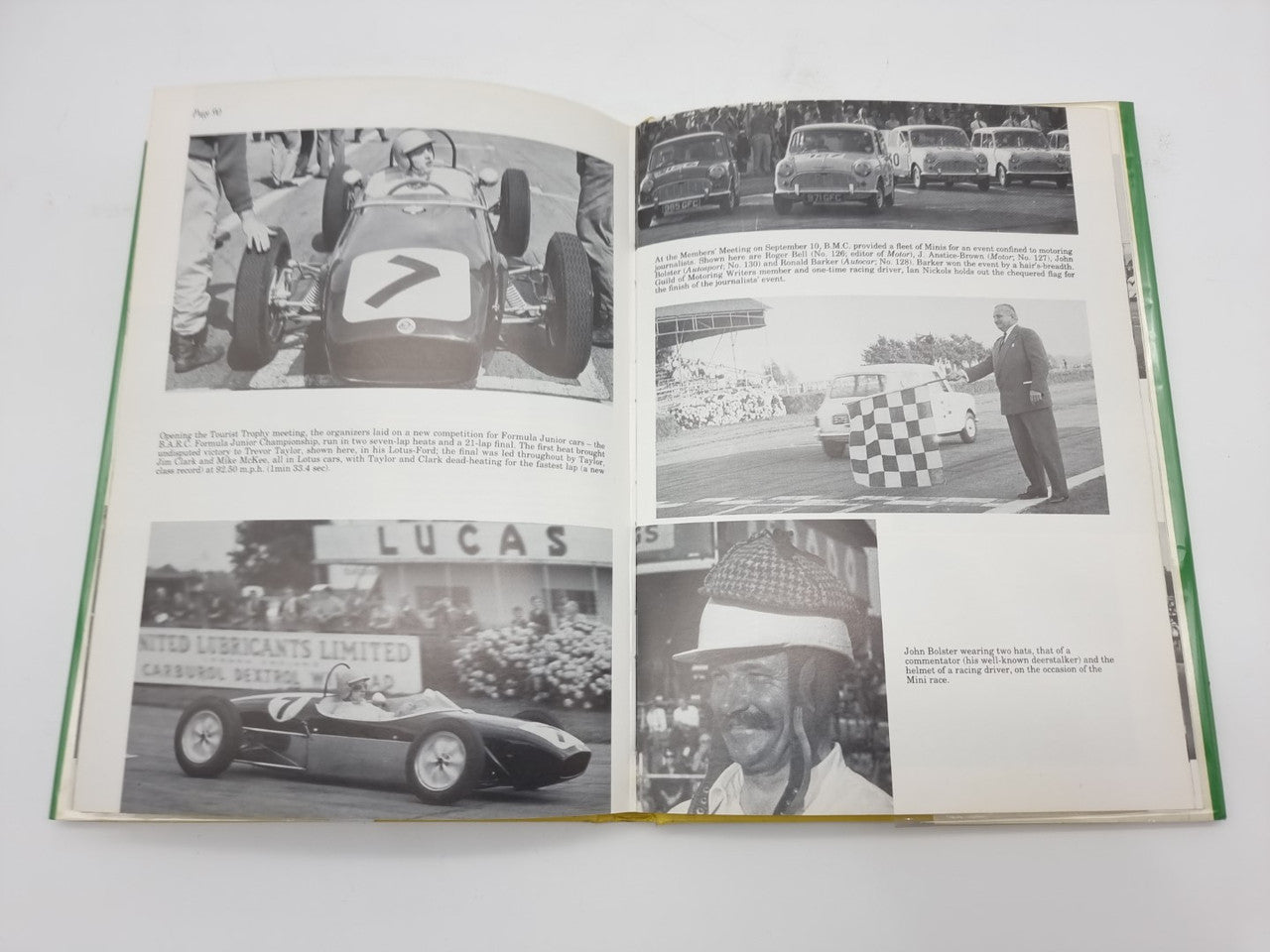 Open hardcover racing history book with race car close-up photos and portrait images.