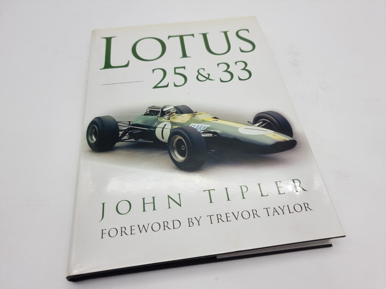 Motorsport hardcover book with green Lotus 25 & 33 title and photo of race car