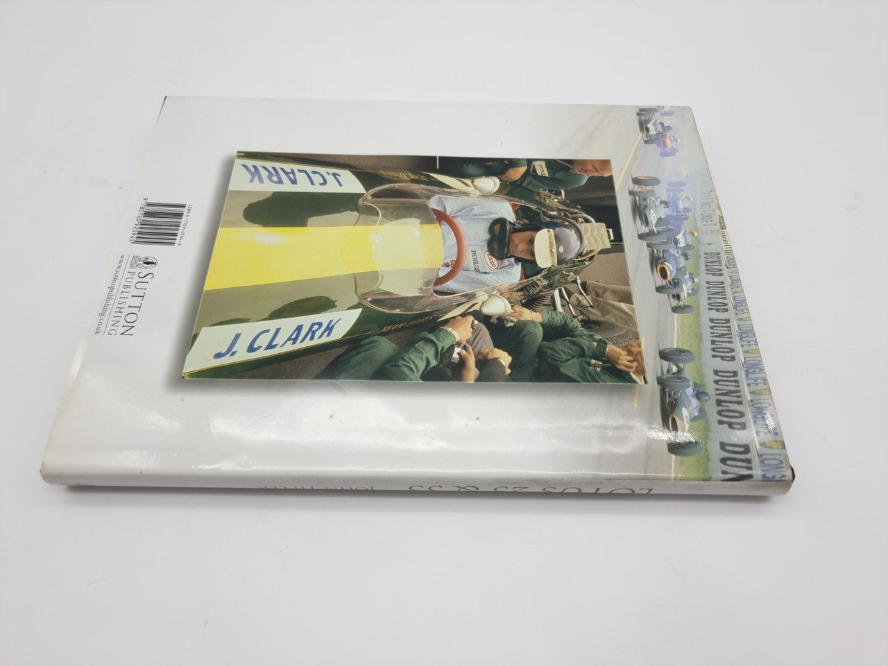 Stacked motorsport books with glossy cover and visible barcode on left volume