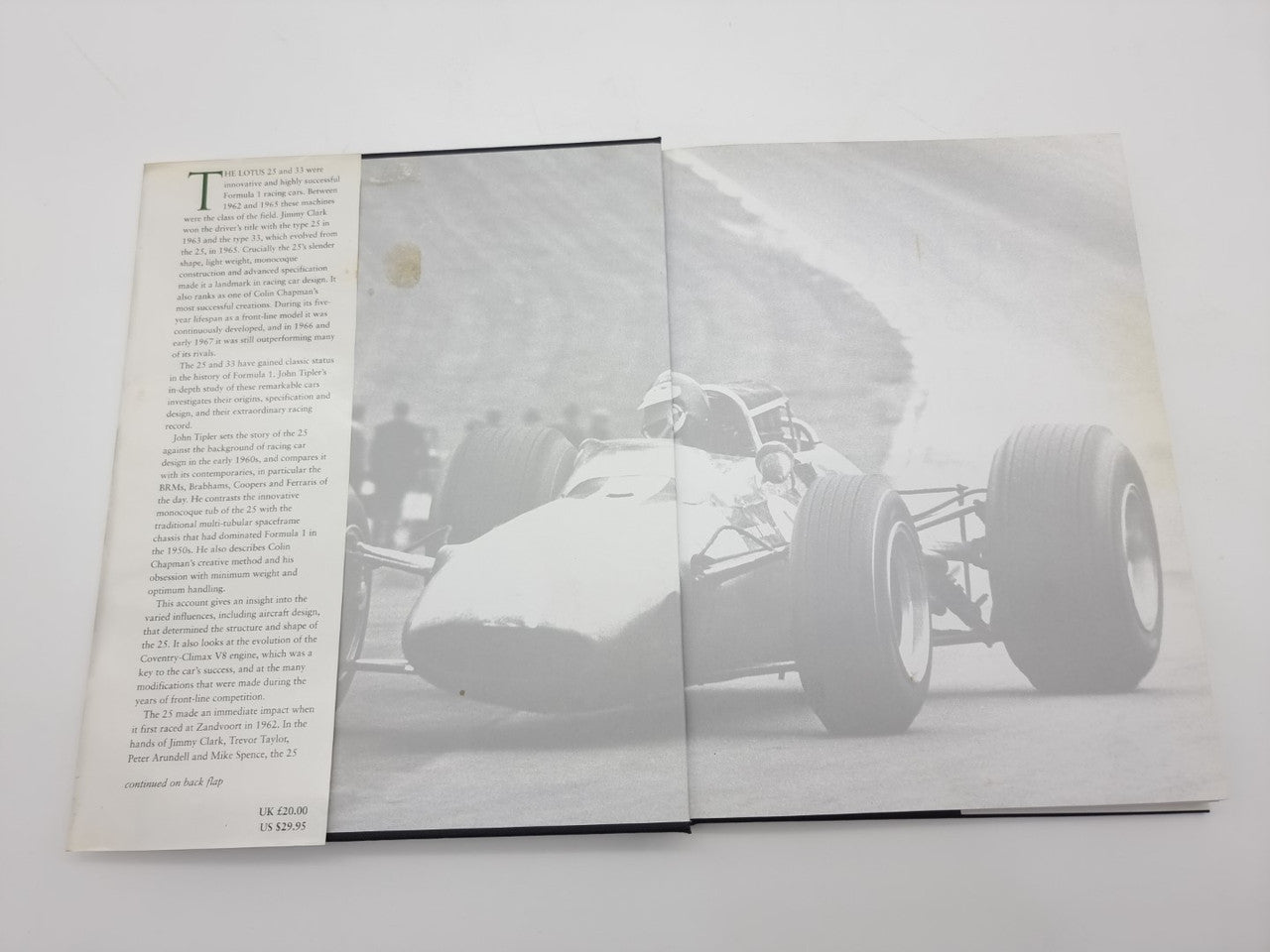 Open Lotus 25 & 33 book with grayscale photo spread and left-side text page