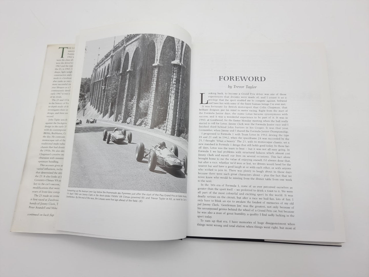 Open book with black-and-white photo spread and dense text pages, hardcover